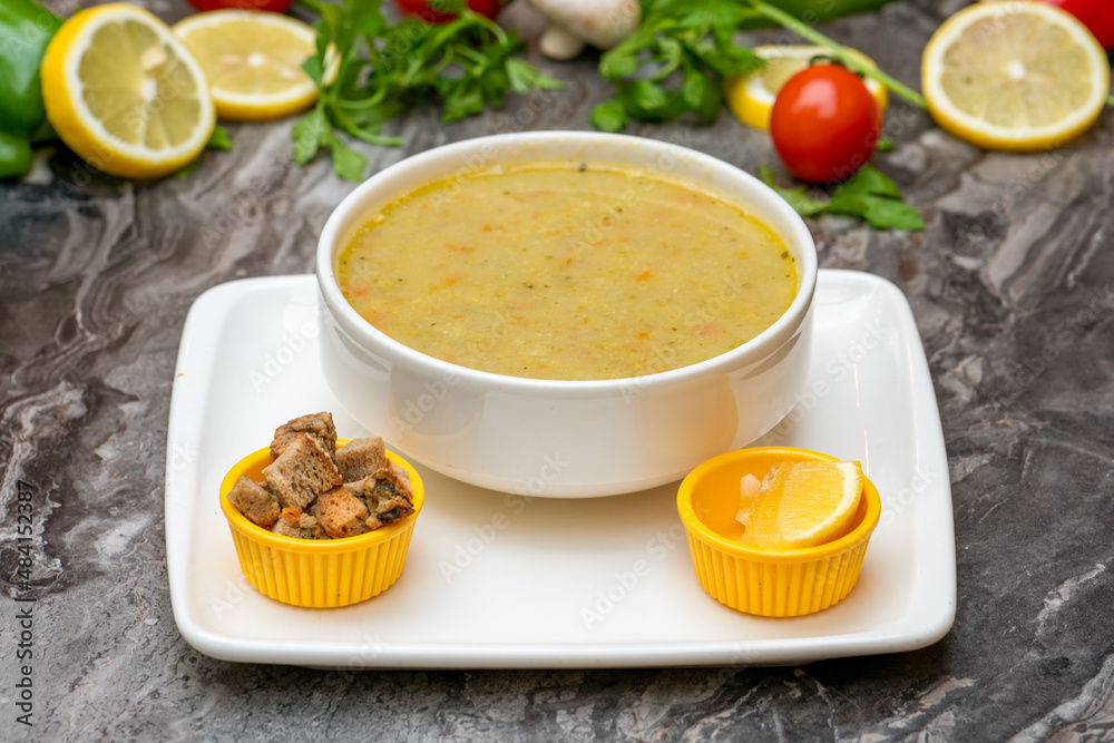 Winter soup with vegetables in a white porcelain bowl Winter soup with vegetables in a white porcelain bowl