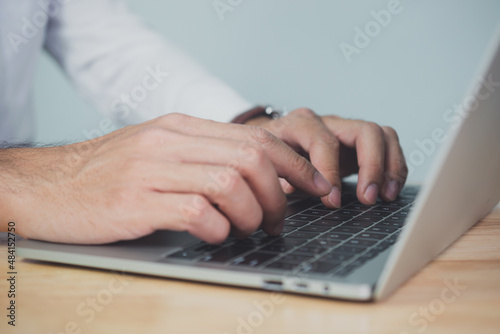 Man hands writing on laptop, close up