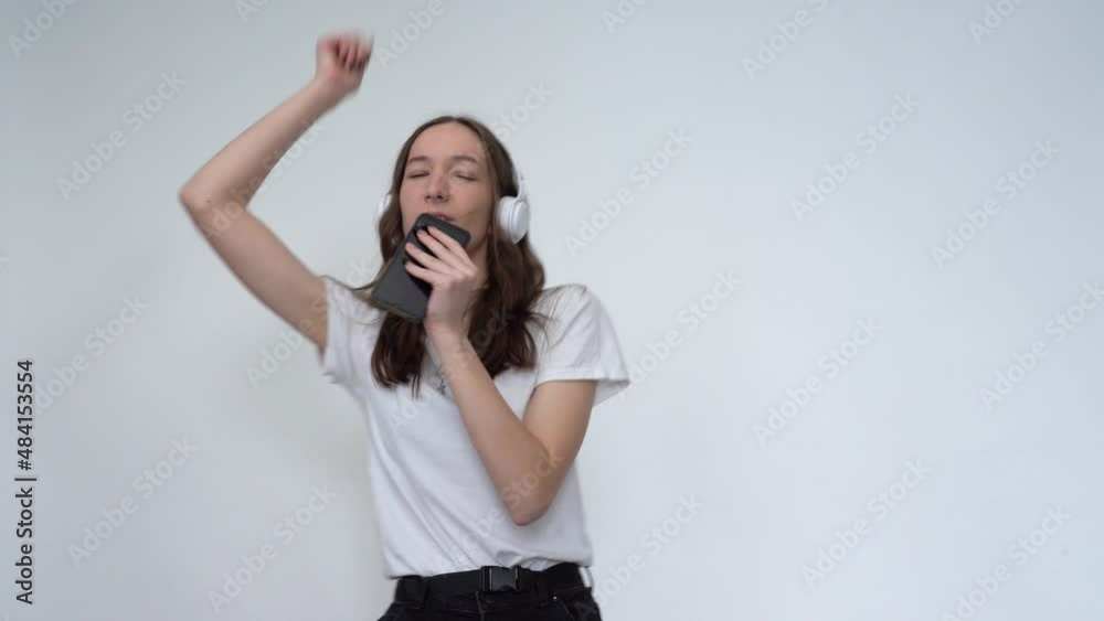 Happy Girl with Headphones Dancing and Singing Happy Girl with Headphones Dancing and Singing