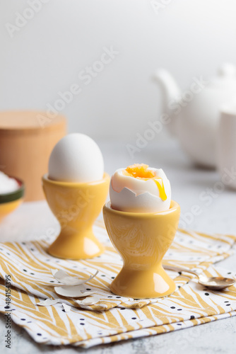 Canvastavla Soft-boiled eggs in yellow egg cups for breakfast, natural and healthy eating, c