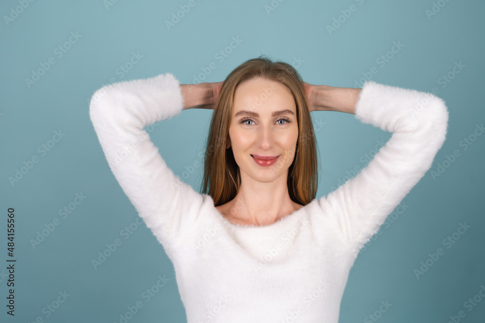 Close beauty portrait of a woman with perfect skin and natural makeup,white soft sweater, on a blue background Close beauty portrait of a woman with perfect skin and natural makeup,white soft sweater, on a blue background