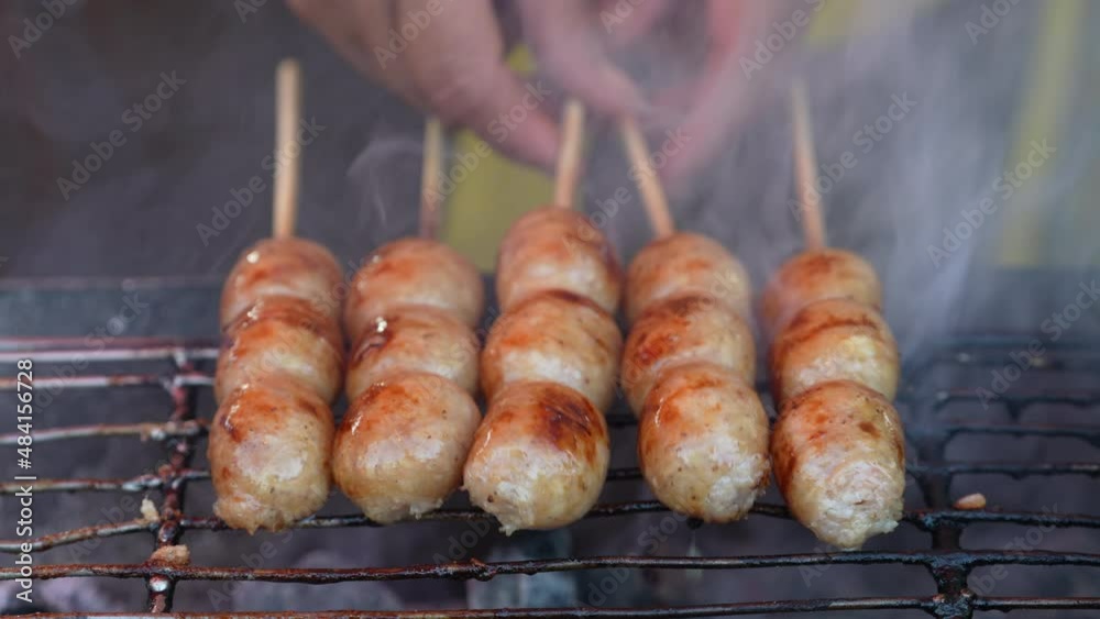 Grilled Thai sausage at street food market in Thailand, close up. Traditional Thai sausage with pork and rice, delicious street food Grilled Thai sausage at street food market in Thailand, close up. Traditional Thai sausage with pork and rice, delicious street food