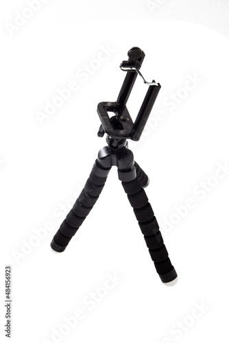 Black tripod for mounting and shooting with a smartphone. Isolation on white.