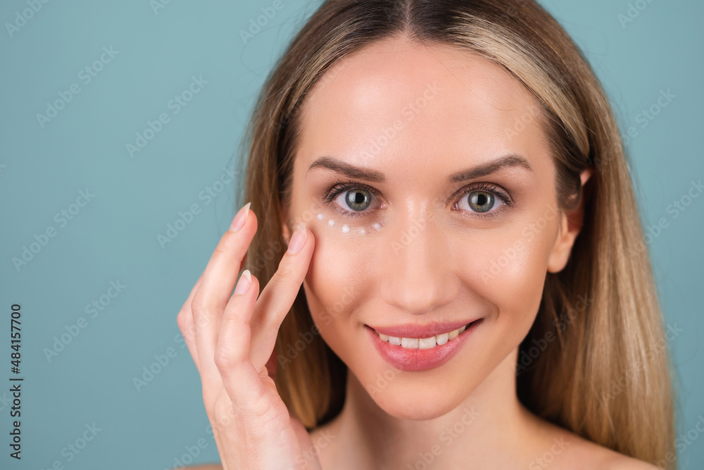 Close-up beauty portrait of a topless woman with perfect skin and natural make-up, with anti-aging cream dots to moisturize and firm the skin under the eyes. Close-up beauty portrait of a topless woman with perfect skin and natural make-up, with anti-aging cream dots to moisturize and firm the skin under the eyes.