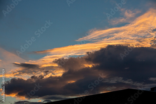Colorful orange and blue dramatic sky with clouds for abstract background over Graz, Austria. © Krasi Kanchev