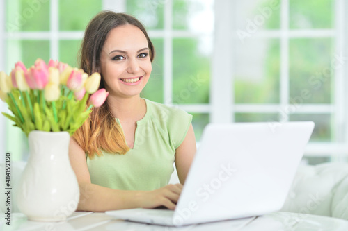 Young business woman with laptop in office