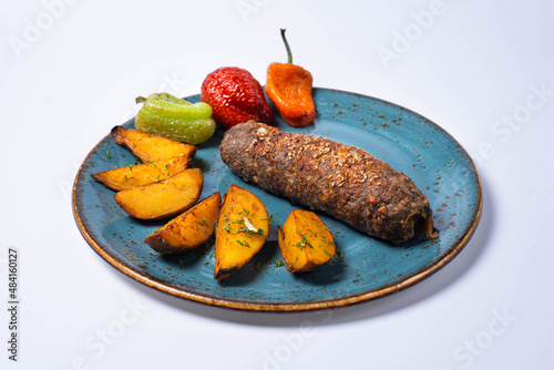 meatloaf with fried potatoes and vegetables. on a white background