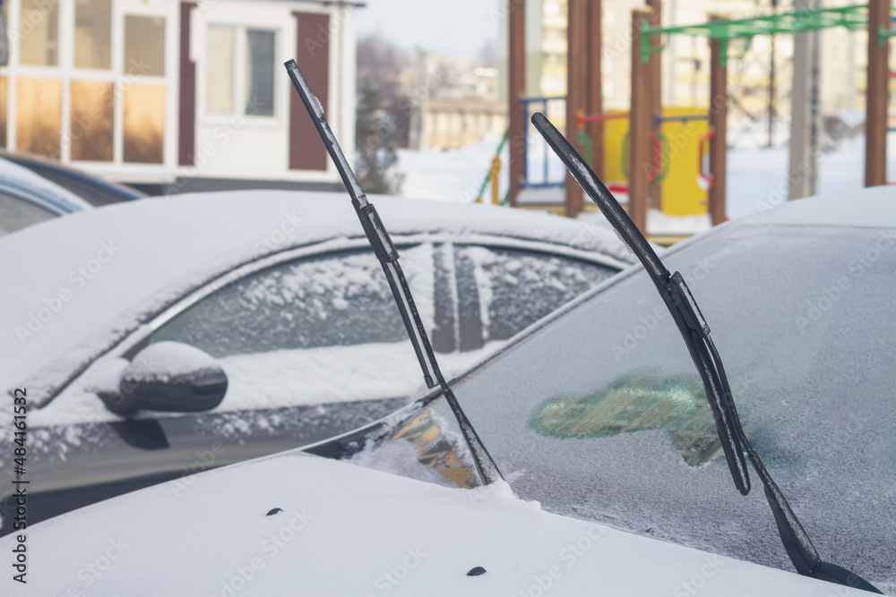 The wipers of the car are raised up so as not to freeze to the window glass in winter