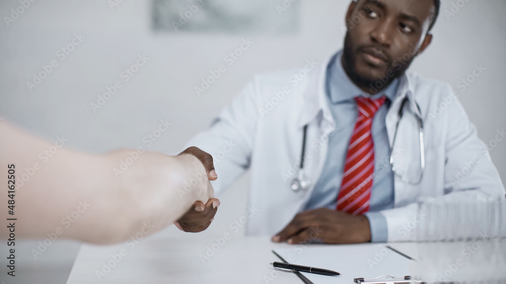 african american doctor shaking hands with patient. african american doctor shaking hands with patient.