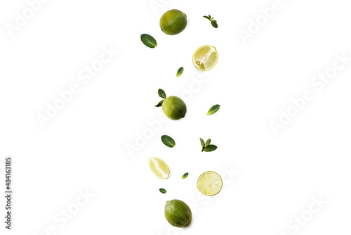 Flying Lime slices with leaves on a white background.