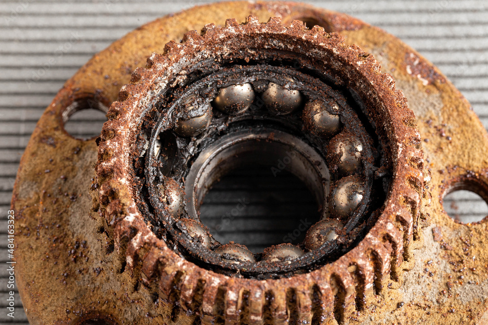Old rusty wheel hub with a broken bearing. Bearing jamming. Automotive Part, close-up. Old rusty wheel hub with a broken bearing. Bearing jamming. Automotive Part, close-up.
