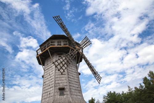 Old wooden mill on blue sky background. Copy space for text, traditional
