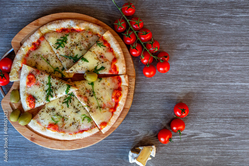 Pizza with Cheese tomatos mozzarela and olives. Photo for menu