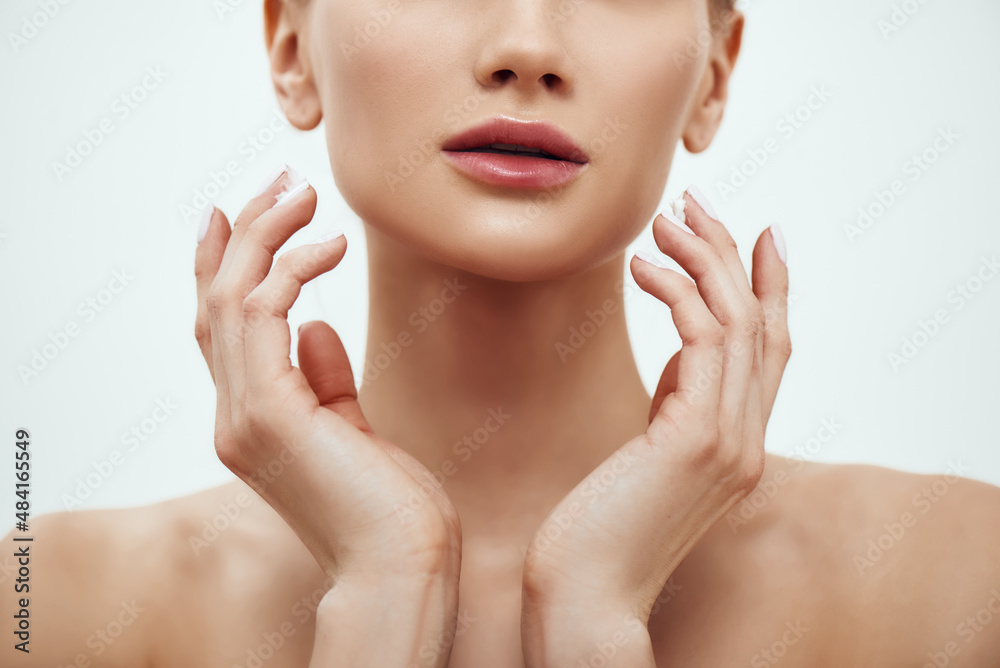Pure beauty. Cropped photo of young blonde woman touching her soft and fresh skin while standing against grey background. Skin care Pure beauty. Cropped photo of young blonde woman touching her soft and fresh skin while standing against grey background. Skin care