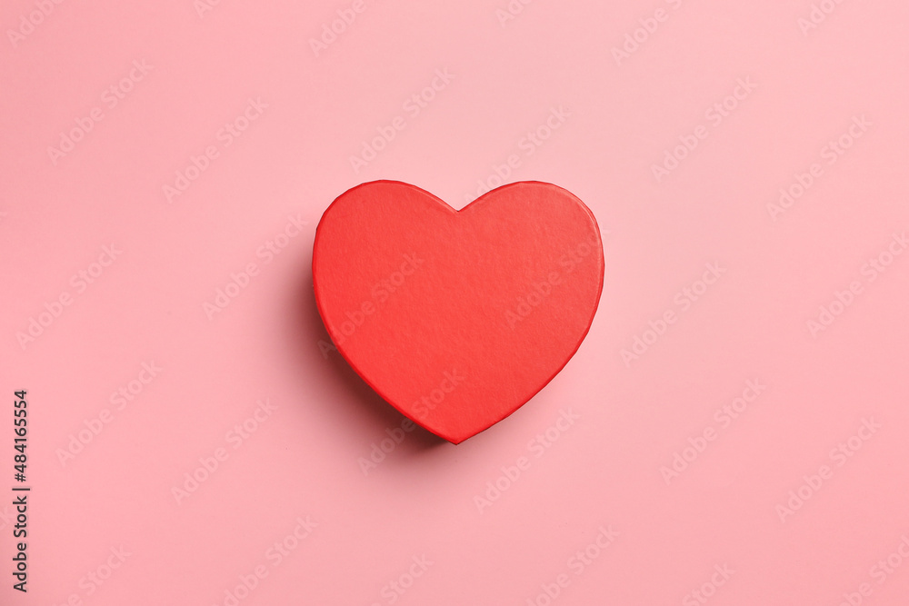 Gift heart  shape red box on pink background. Top view, gift card.