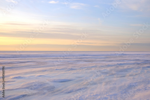 Frozen sea and blue sky. Winter arctic landscape, cold windy and frosty weather
