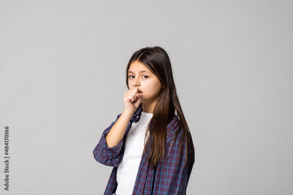 Young girl coughing isolated on gray background Young girl coughing isolated on gray background