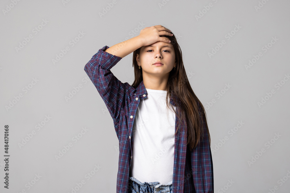 Little girl suffering from sore throat isolated on grey background