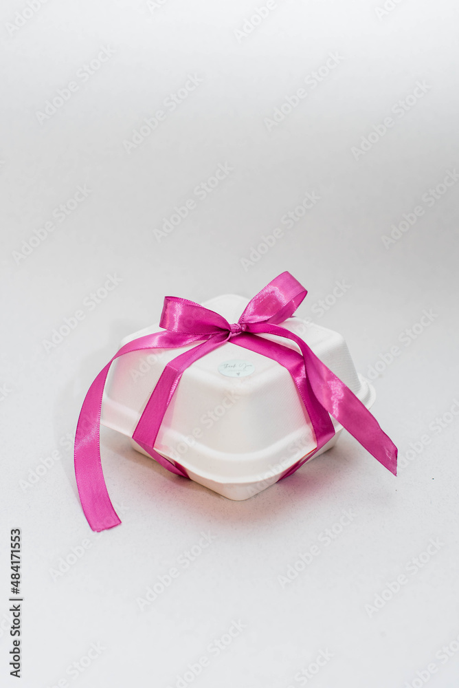 Bento Cake. Portioned trandy dessert for one person in eco box with purple ribbon, small cake. Pink ribbon. Bento Cake. Portioned trandy dessert for one person in eco box with purple ribbon, small cake. Pink ribbon.