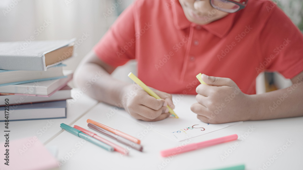 African american boy drawing postcard for Santa Claus, sitting at the table African american boy drawing postcard for Santa Claus, sitting at the table