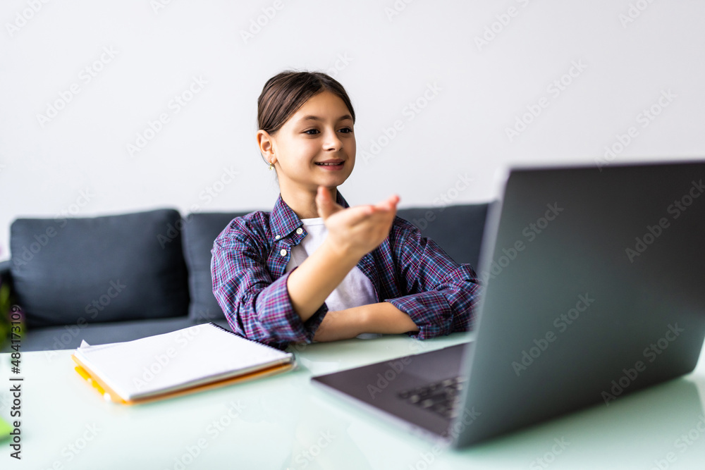 Cheerful girl lying on sofa and having video call with laptop computer. Cheerful girl lying on sofa and having video call with laptop computer.
