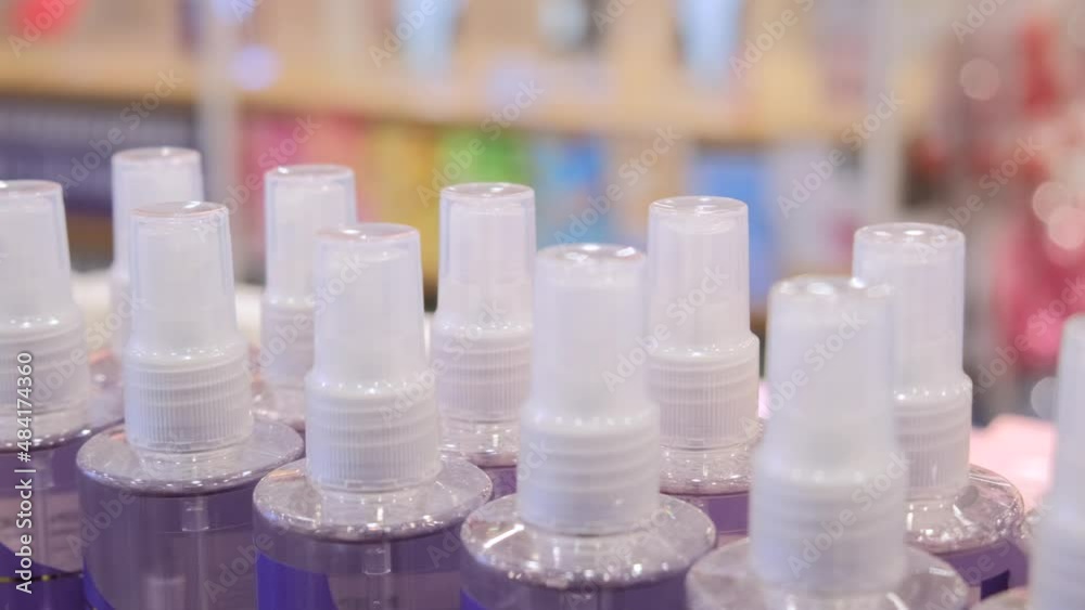 Close up of hygiene products in drugstore, sanitizer, spray, cosmetics, body and hair care liquids bottles in a row Close up of hygiene products in drugstore, sanitizer, spray, cosmetics, body and hair care liquids bottles in a row