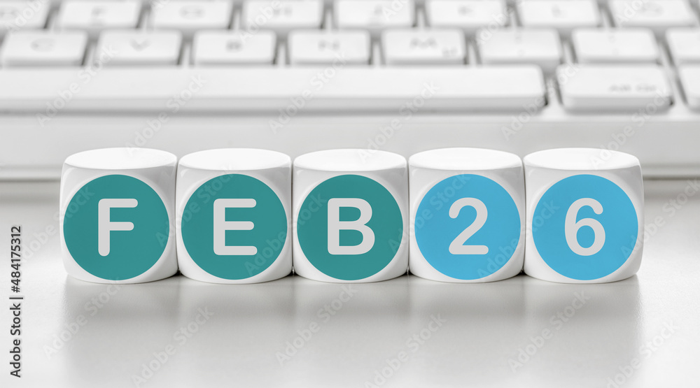 Letter dice in front of a keyboard - February 26