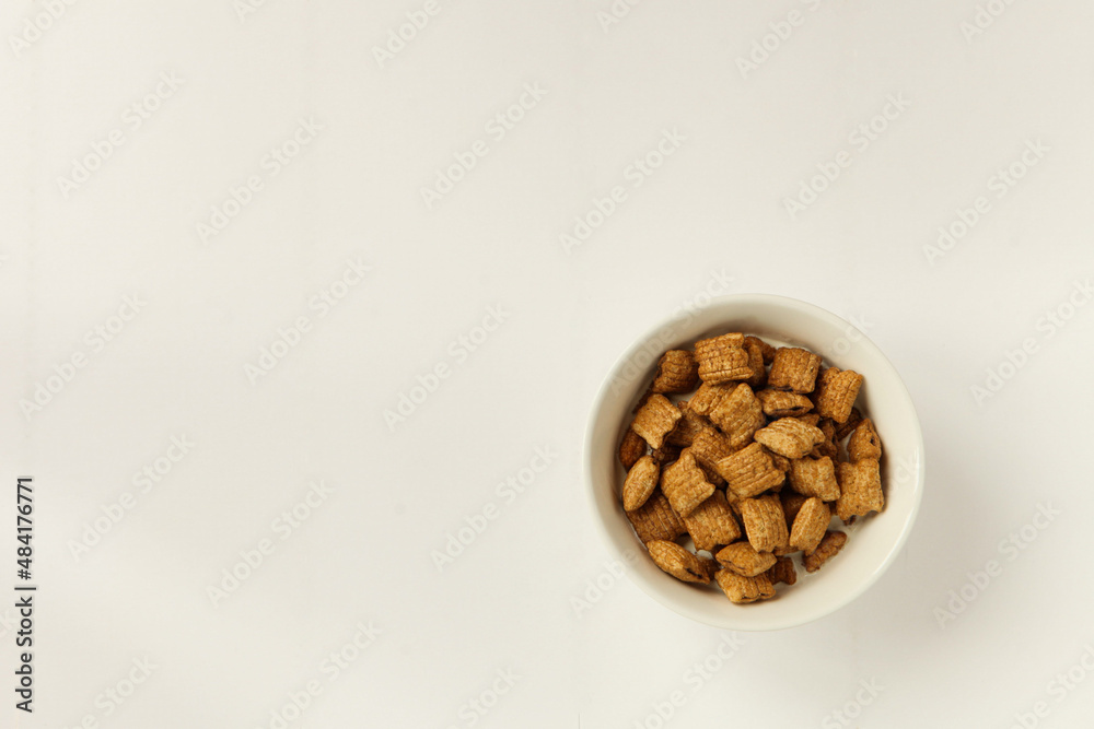bowl with muesli on white background. delicious breakfast with flakes served in a white ceramic bowl bowl with muesli on white background. delicious breakfast with flakes served in a white ceramic bowl