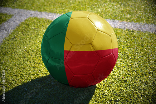 football ball with the national flag of benin lies on the green field