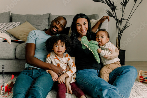 Portrait of smiling multiracial family in living room