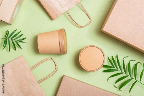 Paper packaging on a soft green background. Food delivery, takeaway. Environmental protection. Zero waste.