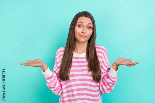 Portrait of attractive indifferent unsure girly girl shrugging shoulders isolated over bright teal turquoise color background