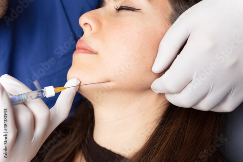 Botox injection to the face in the chin area. aesthetics, medicine concept. Botulinum toxin. youth injections. 