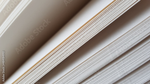 white blank sheets of thick notepad, half opened end view