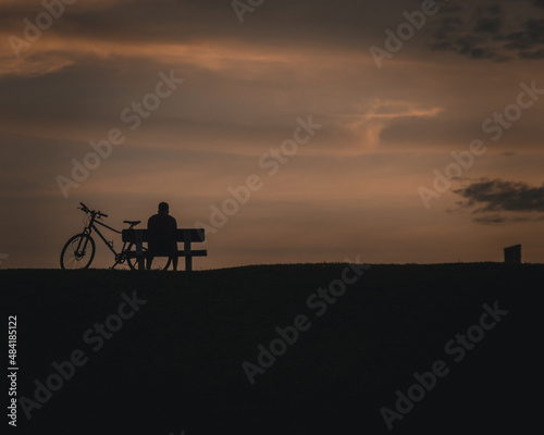 silhouette of a person riding a bicycle © som