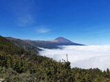 Clouds over the Teide National Park and volcano on the Island of Tenerife. Sea of clouds. Landscapes and extreme nature.