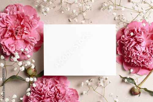 Wedding invitation card mockup with pink peony and gypsophila flowers photo