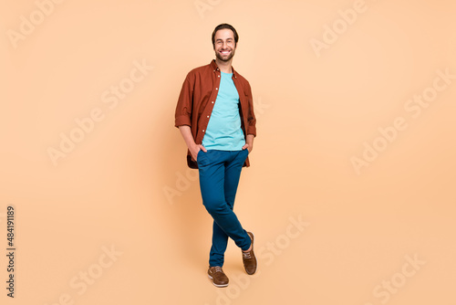 Photo of confident successful businessman hands pockets look camera wear casual outfit isolated beige color background