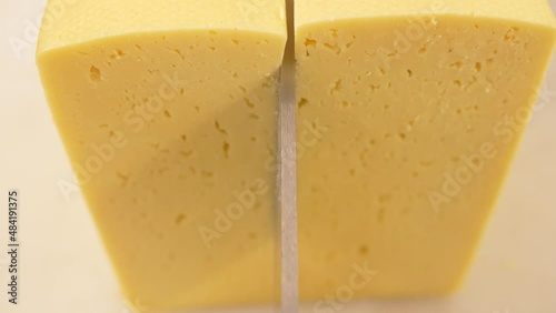 Large cutter cuts a piece of cheese