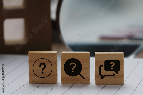 Frequently asked question icon on a wooden cube