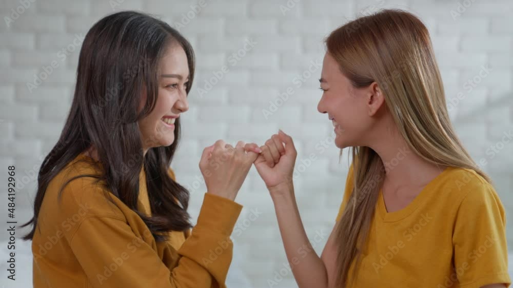 Woman and female hook each other's little finger. Metaphor Pledges and Promises Asian Lesbian Couples at Home Lesbian, Gay, Bisexual, Transgender, LGBTQ+ Couples Equality. gestures of reconciliation. Woman and female hook each other's little finger. Metaphor Pledges and Promises Asian Lesbian Couples at Home Lesbian, Gay, Bisexual, Transgender, LGBTQ+ Couples Equality. gestures of reconciliation.
