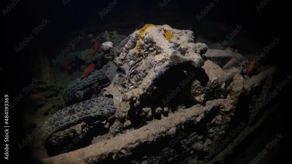Close up of several motorcycles left inside the Thistlegorm shipwreck in the Red Sea, Egypt. Dark and moody room inside the ship, lit up by a flashlight. Close up of several motorcycles left inside the Thistlegorm shipwreck in the Red Sea, Egypt. Dark and moody room inside the ship, lit up by a flashlight.