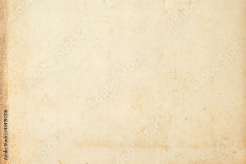 Old brown vintage paper background. Grungy surface texture. Art and craft concept. Retro paperboard backdrop. Antique and classic style. Blank sheet scrapbook.