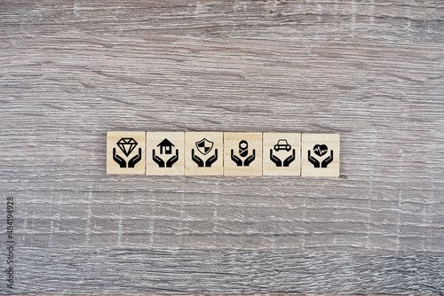 An insurance icon on a wooden cube
