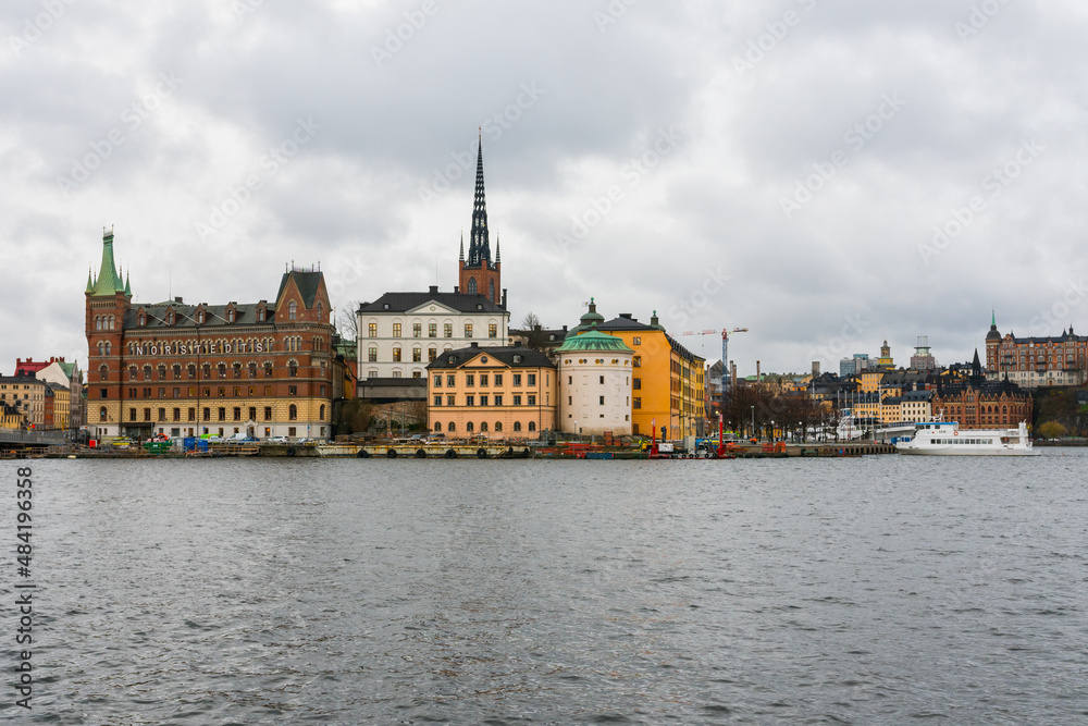 Stockholm, Sweden. Overview of Gamla Stan old town with the baltic sea in the foreground. Cloudy day in Sweden. Stockholm, Sweden. Overview of Gamla Stan old town with the baltic sea in the foreground. Cloudy day in Sweden.