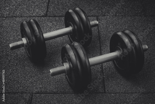 Pair of black dumbbells On the floor black and white photography