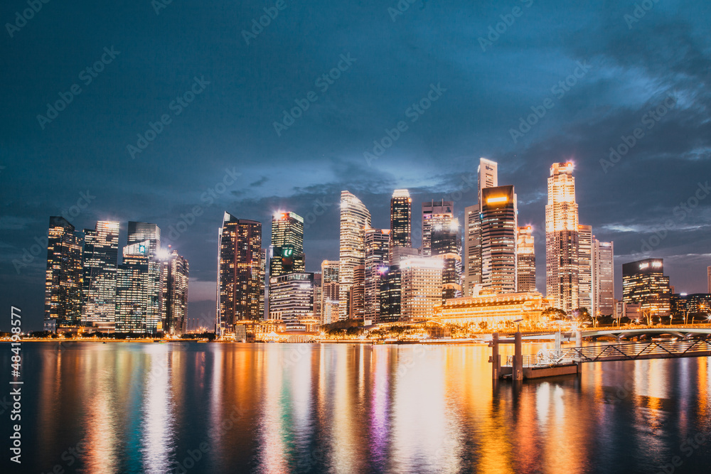 SINGAPORE, SINGAPORE - MARCH 2019: Skyline of Singapore Marina Bay at night with Marina Bay sands, Art Science museum , skyscrapers and tourist boats