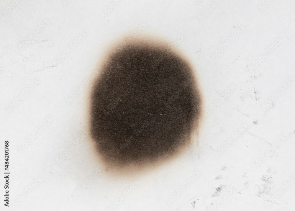 © Илья Подопригоров - Paper burn black  stain isolated over the white background. Round paper burn mark close up
