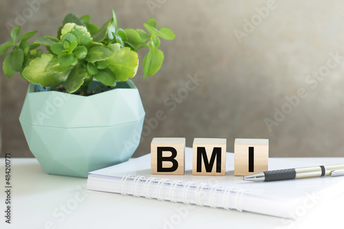 Wooden block form the word BMI on doctor's table, medical concept
