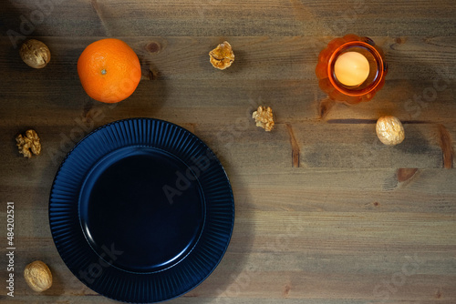 Empty black plate on a wooden table. View from above.